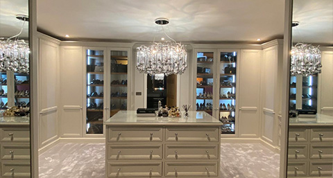 Stylish gray kitchen cabinets with sleek handles and a modern island countertop.